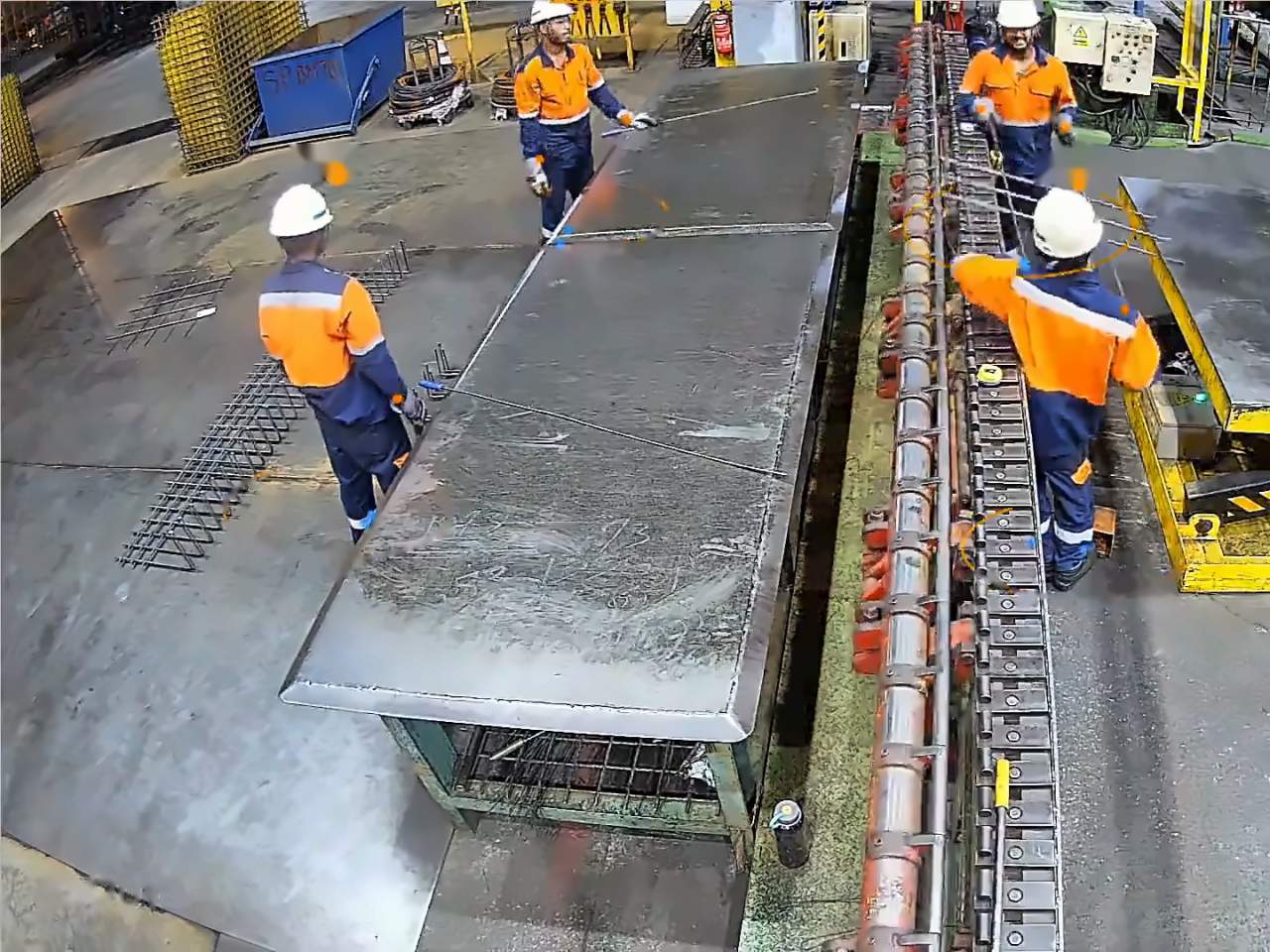 Factory-floor camera: workers in hard hats, vests and gloves, each boxed by Ailytics.